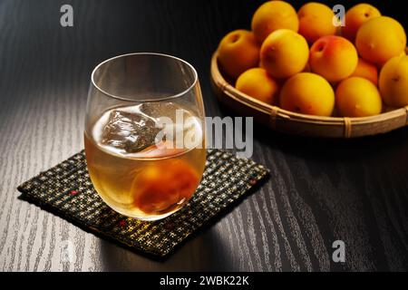 plum wine on a wood grain table Stock Photo