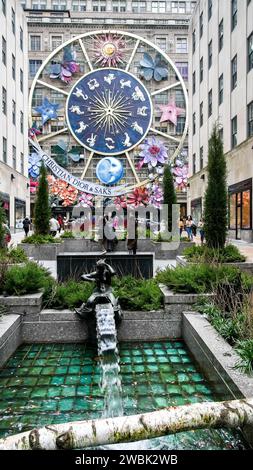 NEW YORK CITY, NEW YORK, USA - JANUARY 10, 2024: Beautiful Christmas decoration on Saks at Fifth avenue with pedestrians, vertical view Stock Photo