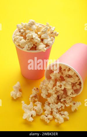 Popcorn in pink cups. Three cups of popcorn on yellow background. Sweet popcorn. Top view Stock Photo