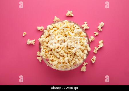 Popcorn in glass bowl on pink background.Top wiew. Stock Photo