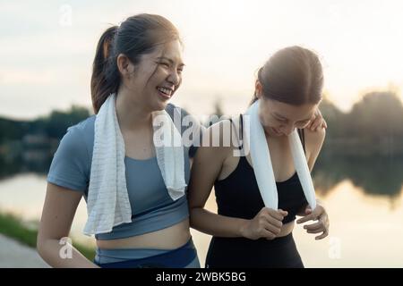 Fit friends woman are jogging in the park, having fun, taking a break Stock Photo