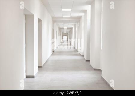 empty hallway, very long corridor with many doors for rooms of hospital, hotel, school or laboratory, building with many office, campus for medical an Stock Photo