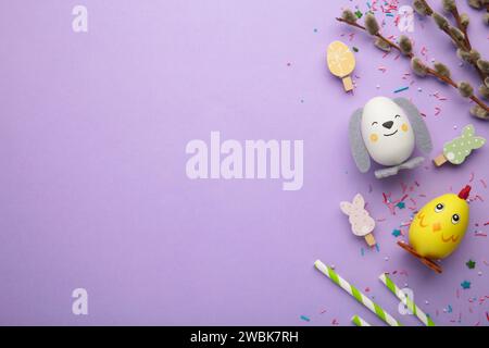 Easter holiday concept with cute handmade eggs, chicks and bunny on purple background. Top view. Happy Easter Stock Photo