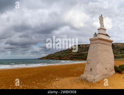 Ramla Bay, Malta - 20 December, 2023: view of the red sand beach and Staue of Our Lady in Ramla Bay on Gozo Island in Malta Stock Photo