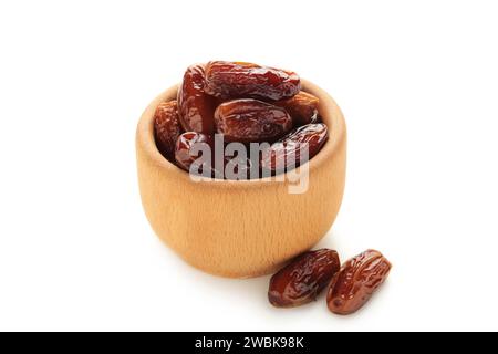 Wooden bowl of dried dates isolated on white background. Stock Photo