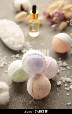 Composition with bath bombs, sea salt, dry flowers on grey background Stock Photo