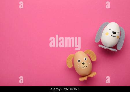 Easter eggs cute bunny and dog on pink background. Top view Stock Photo
