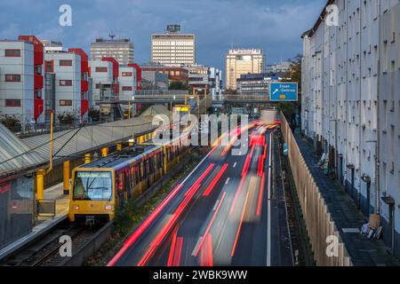 Essen, North Rhine-Westphalia, Germany - Autobahn A40 in the city center, exit Essen Zentrum, during evening twilight. Subway line U18 on the way to B Stock Photo
