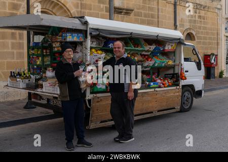 Zebbug, Malta - 19 December, 2023: mobile greengrocer and senior citizen customer in a remote village on Gozo Island in Malta Stock Photo