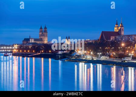 Magdeburg Cathedral, to the right of it Our Lady's Monastery and St. John's Church, twilight, lights reflected in the Elbe, Magdeburg, Saxony-Anhalt, Germany Stock Photo