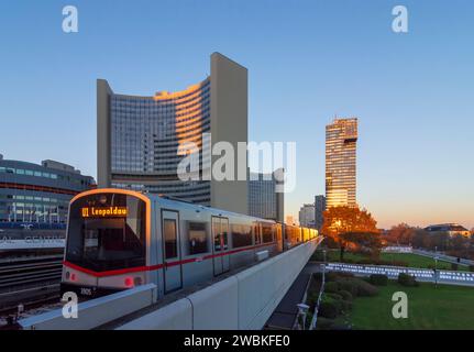 Vienna, train of subway line U1 at station Kaisermühlen - Vienna International Centre, building of Vienna International Centre (VIC) and IZD Tower in 22. district Donaustadt, Austria Stock Photo