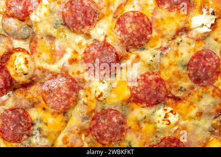 Background with delicious classic italian Pizza Pepperoni with sausages and cheese mozzarella. Fresh italian classic original pepperoni pizza. Stock Photo