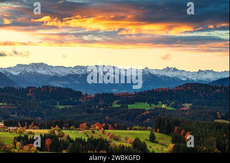 Colorful sunrise in the foothills of the Alps in autumn. View of the snow-covered Allgäu Alps above the Illertal. Bavaria, Germany, Europe Stock Photo