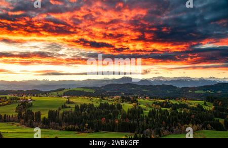 Colorful sunrise in the foothills of the Alps in autumn. View of the snow-covered Allgäu Alps with Grünten. Bavaria, Germany, Europe Stock Photo