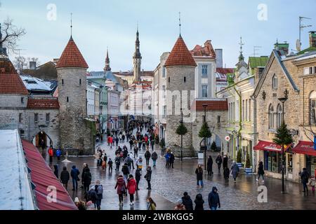 Tallinn, Estonia - Old Town of Tallinn, clay gate, watchtowers of the medieval city gate Viru, the Viru is the main shopping street in the city, behind the tower of the town hall at the town hall square. Stock Photo