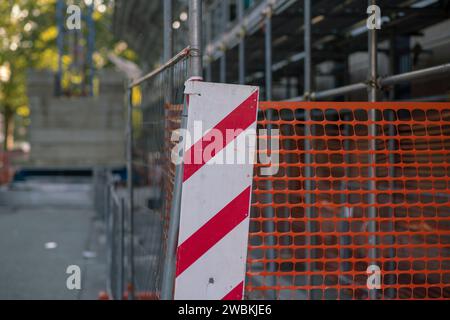 high visibility net, work in progress on a construction site, fence of a construction site with highly visible colored elements. white, red and orange Stock Photo