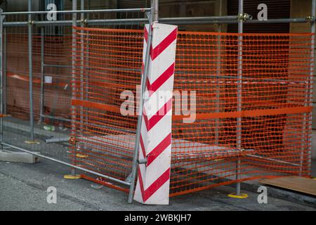 high visibility net, work in progress on a construction site, fence of a construction site with highly visible colored elements. white, red and orange Stock Photo