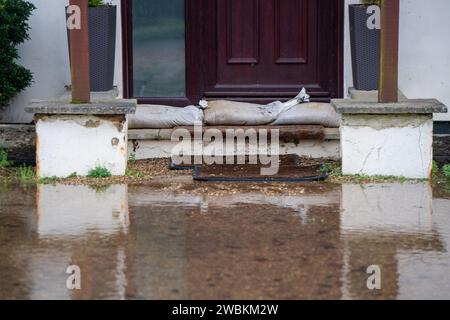 Wraysbury, UK. 11th January, 2024. Some gardens remain flooded in Wraysbury, Berkshire after the River Thames burst its banks earlier this week. After a terrible week for some residents near the River Thames the flooding is finally subsiding in Wraysbury, Berkshire. Now the clean up begins. Credit: Maureen McLean/Alamy Live News Stock Photo