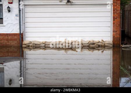 Wraysbury, UK. 11th January, 2024. Some gardens remain flooded in Wraysbury, Berkshire after the River Thames burst its banks earlier this week. After a terrible week for some residents near the River Thames the flooding is finally subsiding in Wraysbury, Berkshire. Now the clean up begins. Credit: Maureen McLean/Alamy Live News Stock Photo