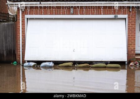 Wraysbury, UK. 11th January, 2024. Some gardens remain flooded in Wraysbury, Berkshire after the River Thames burst its banks earlier this week. After a terrible week for some residents near the River Thames the flooding is finally subsiding in Wraysbury, Berkshire. Now the clean up begins. Credit: Maureen McLean/Alamy Live News Stock Photo