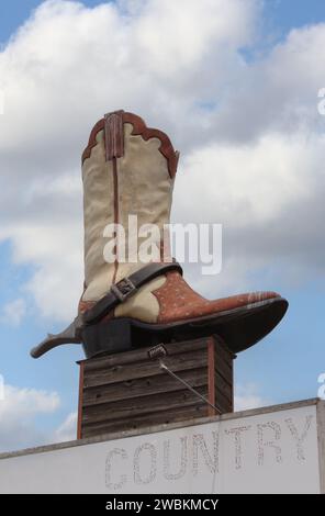 Giant Cowboy Boot on Sign of Abandoned Business Located in Rural Texas. Weir Texas Stock Photo