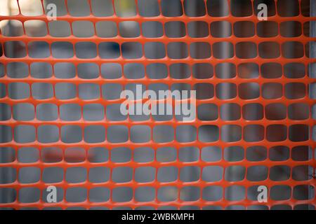 high visibility net, work in progress on a construction site, fence of a construction site with highly visible colored elements. white, red and orange Stock Photo