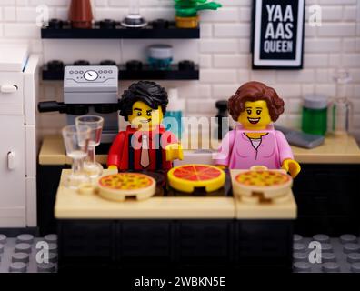 Tambov, Russian Federation - June 22, 2023 Lego man and woman minifigures standing in a kitchen with pizzas Stock Photo