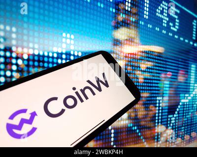 Konskie, Poland - January 05, 2024: CoinW cryptocurrency exchange logo displayed on smartphone on crypto market data background Stock Photo