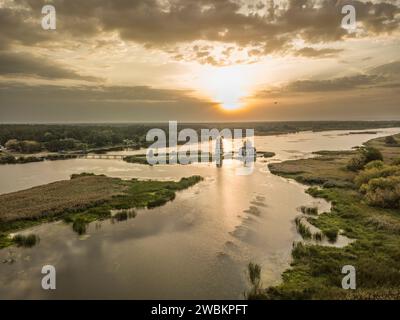 The gentle light of the rising sun illuminates the famous flooded church in Gusintsy and creates beautiful reflections on the water, Ukraine Stock Photo