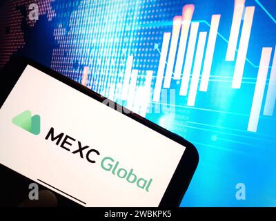 Konskie, Poland - January 05, 2024: MEXC cryptocurrency exchange logo displayed on smartphone on crypto market data background Stock Photo