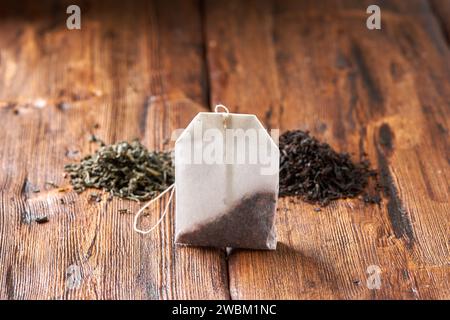 Tea bag, green and black tea on an old wooden table. Stock Photo