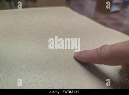 Blind male reading braille language book at library. Selective focus Stock Photo