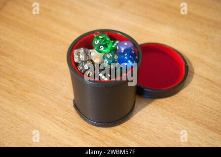 Black dice cup filled with dice Stock Photo