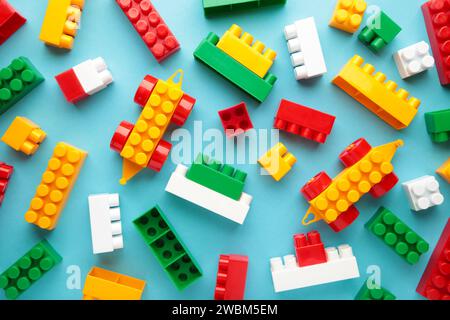 Multicolored blocks of the children's constructor lie on a blue background Stock Photo