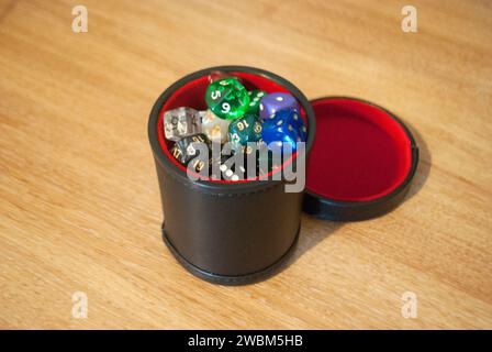 Black dice cup filled with dice Stock Photo