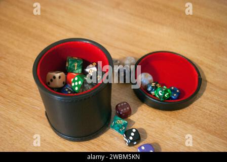 Black dice cup filled with dice Stock Photo