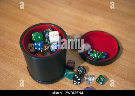 Black dice cup filled with dice Stock Photo