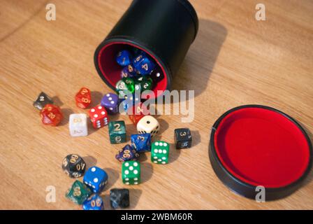 Dice spilling from black dice cup Stock Photo