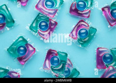 Laundry capsule detergent pods for washing clothes on blue background. Top view Stock Photo