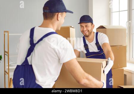 Two Movers Working on Home or Office Move with Cardboard Boxes Stock Photo