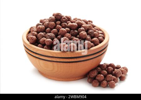 Chocolate corn balls in wooden bowl isolated on white background. Top view. Stock Photo