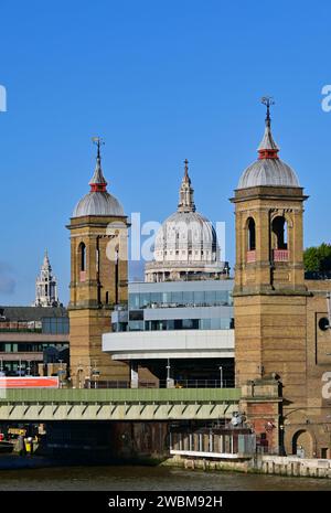 The dome of St Paul's Cathedral between the twin towers of Cannon Street railway station on the north bank of the River Thames, London, England, UK . Stock Photo