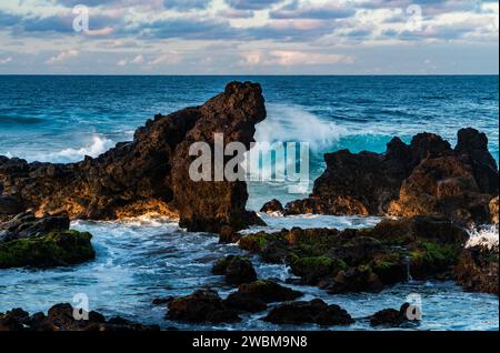 Mighty waves break on Ho'okipa's volcanic rocks, a testament to Maui's untamed coastal allure. Stock Photo