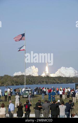 CAPE CANAVERAL, Fla. - Space shuttle Discovery's liftoff from Launch Pad 39A at NASA's Kennedy Space Center in Florida on a picturesque, warm, late February afternoon is witnessed by news media representatives near the countdown clock at the Press Site. Launch of the STS-133 mission was at 4:53 p.m. EST on Feb. 24. Discovery and its six-member crew are on a mission to deliver the Permanent Multipurpose Module, packed with supplies and critical spare parts, as well as Robonaut 2, the dexterous humanoid astronaut helper, to the International Space Station. Discovery is making its 39th mission an Stock Photo