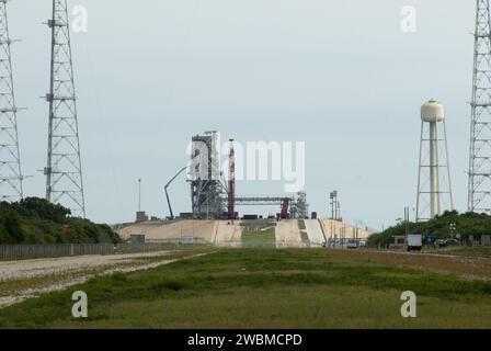 Workers dismantle the final sections of the rotating service structure on Launch Pad 39B at Kennedy Space Center, preparing the pad for future rocket launches with a clean pad design and retaining the lightning protection system. Stock Photo