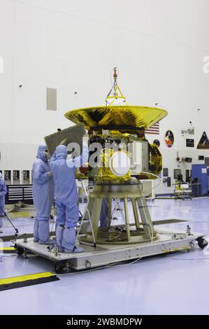 Technicians at Kennedy Space Center installed panels on New Horizons to protect it beneath the antenna and maintain operating temperatures. New Horizons will perform the first reconnaissance of Pluto and Charon, mapping surface colors, methane frost, and composition using ultraviolet and near-infrared spectral imaging. Stock Photo