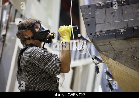 CAPE CANAVERAL, Fla. -- In Orbiter Processing Facility-1 at NASA’s Kennedy Space Center in Florida, a technician wearing safety equipment inspects shuttle Endeavour’s left-hand orbital maneuvering system, or OMS, pod, while the component is removed using a large overhead crane. The work is part of Endeavour’s transition and retirement processing. The spacecraft is being prepared for public display at the California Science Center in Los Angeles. Endeavour flew 25 missions, spent 299 days in space, orbited Earth 4,671 times and traveled 122, 883, 151 miles over the course of its 19-year career. Stock Photo