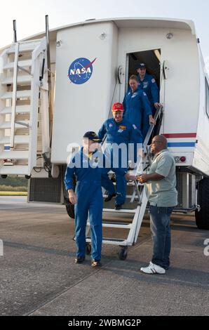 STS135-S-195 (21 July 2011) --- NASA astronaut Chris Ferguson, STS-135 commander, leads his crew out of the Crew Transport Vehicle (CTV) following brief and standard medical checks. Behind Ferguson are NASA astronauts Doug Hurley, pilot; Sandy Magnus and Rex Walheim, both mission specialists. The final four astronauts of NASA's Space Shuttle Program brought space shuttle Atlantis home to the Shuttle Landing Facility's Runway 15 at NASA's Kennedy Space Center in Florida at 5:57 a.m. (EDT) on July 21, 2011. Atlantis' final return from space completed a 13-day, 5.2-million-mile journey to the Int Stock Photo