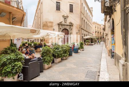 Trapani, Sicily, Italy - September 20, 2016: Street with outdoor bars in the historic center of Trapani. Stock Photo