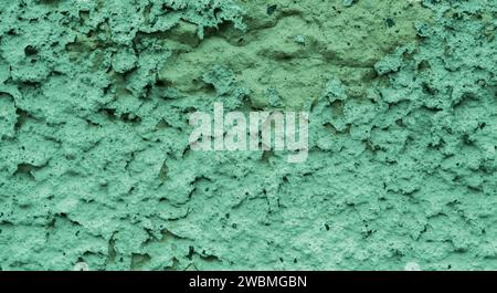 Old peeling paint on the wall..Green abstract background..Beautiful green textured stucco on the wall..Background from green stucco. Stock Photo